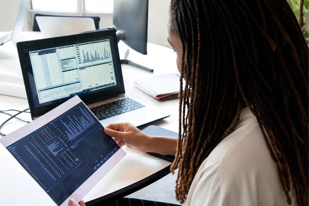 Woman reviewing analytics reports and performance data on a laptop