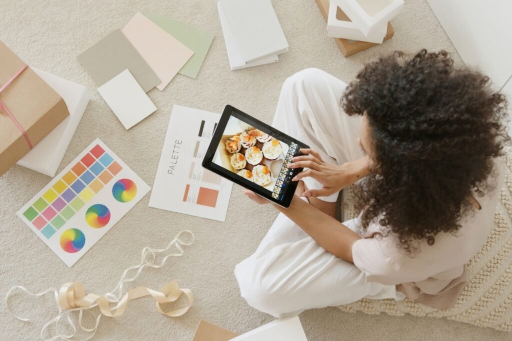 Creator reviewing visual design assets and images on a tablet for a content batch