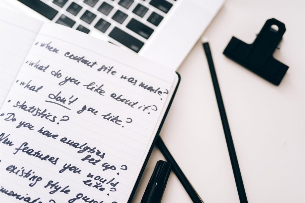 Notebook with content questions and planning prompts for developing multiple Pinterest angles