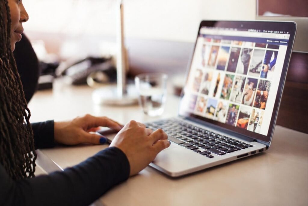 Creator reviewing a collection of visual content on a laptop for new Pinterest ideas